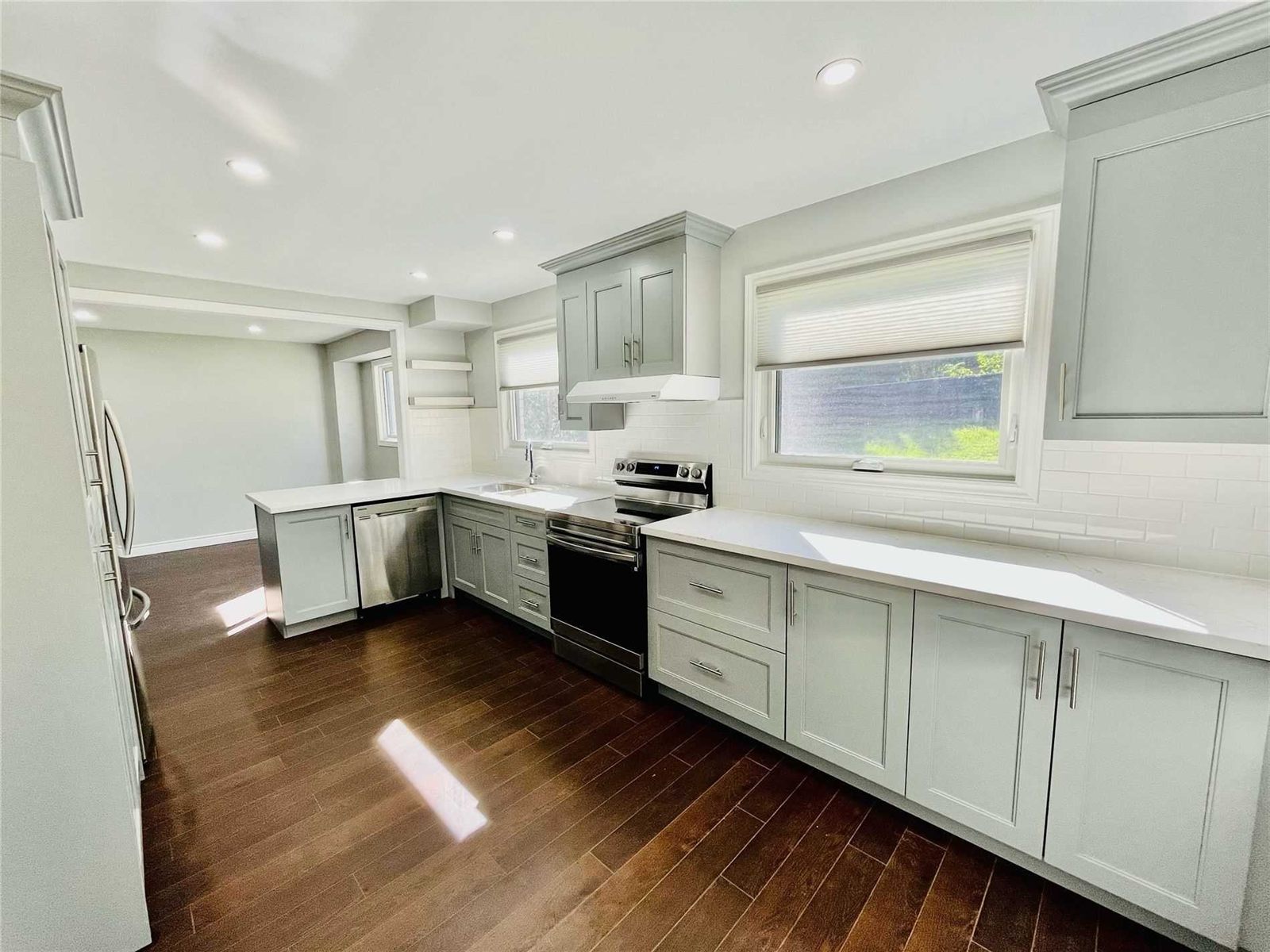 Full kitchen renovation with new cabinets, quartz counters and hardwood floors