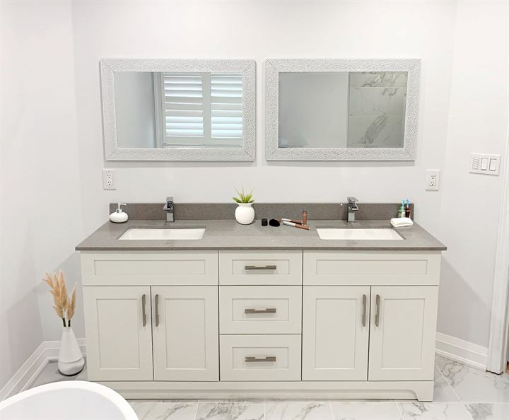 Master bathroom with double vanity and marble-look porcelain floor